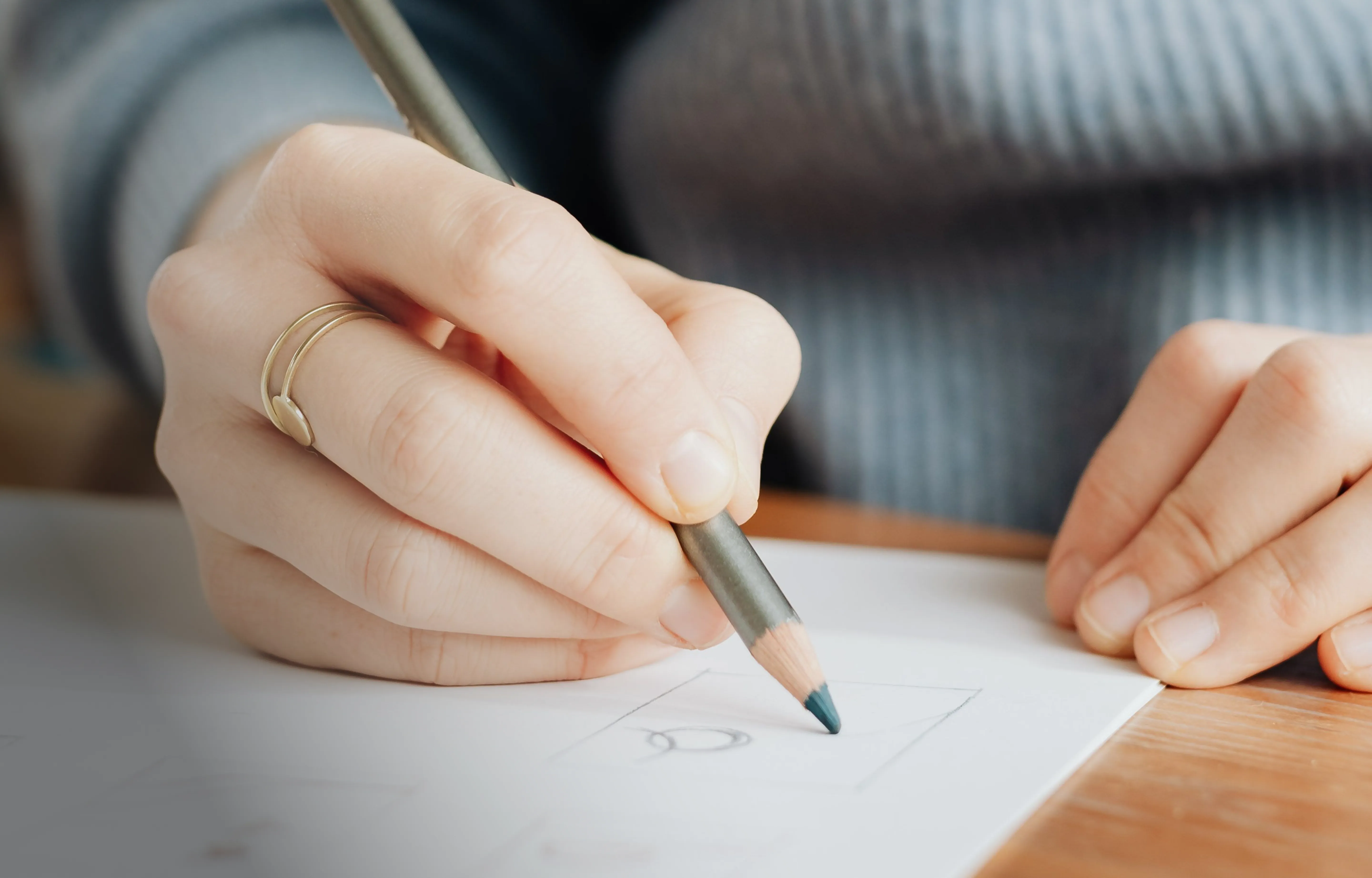 A designer sketching a logo concept in pencil