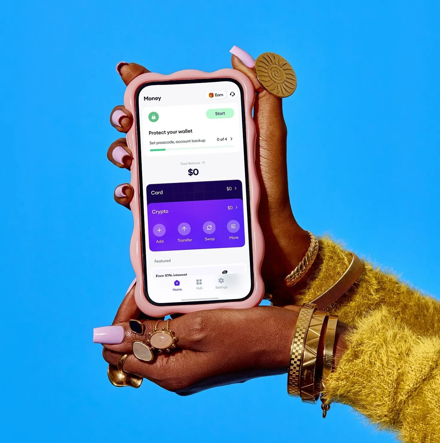 A banking app on a phone held in a hand against a blue backdrop