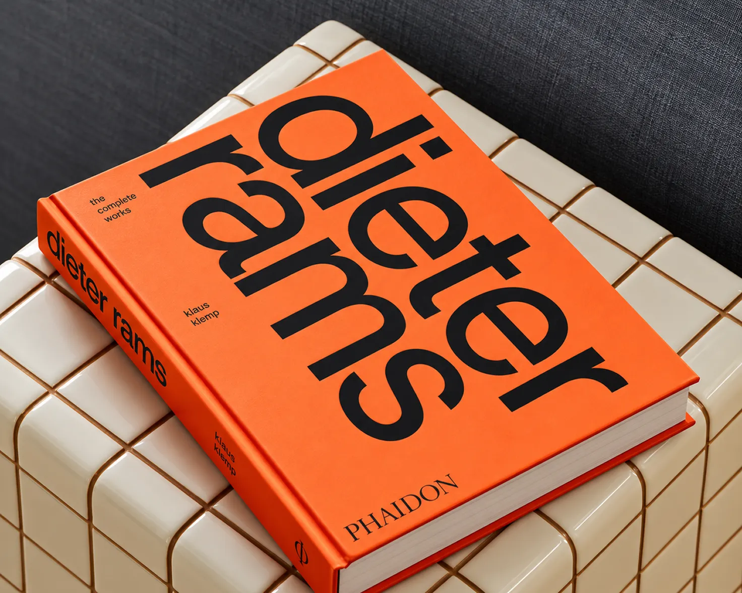 Editorial book cover design in orange with bold black type