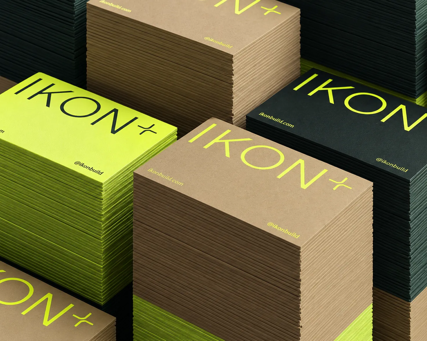 Stacks of branded business cards in three colourways