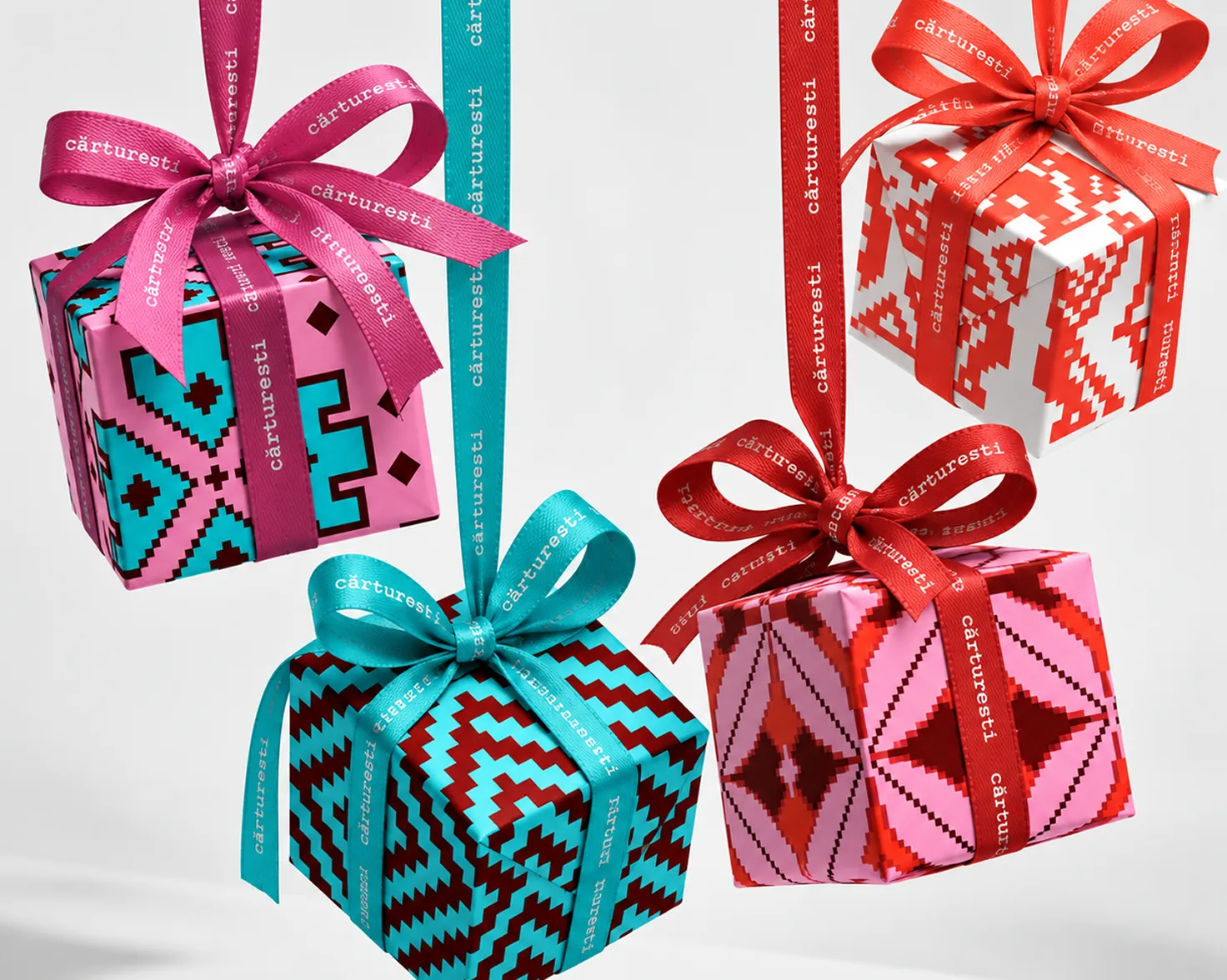 Patterned gift boxes tied with ribbon, hanging in a row