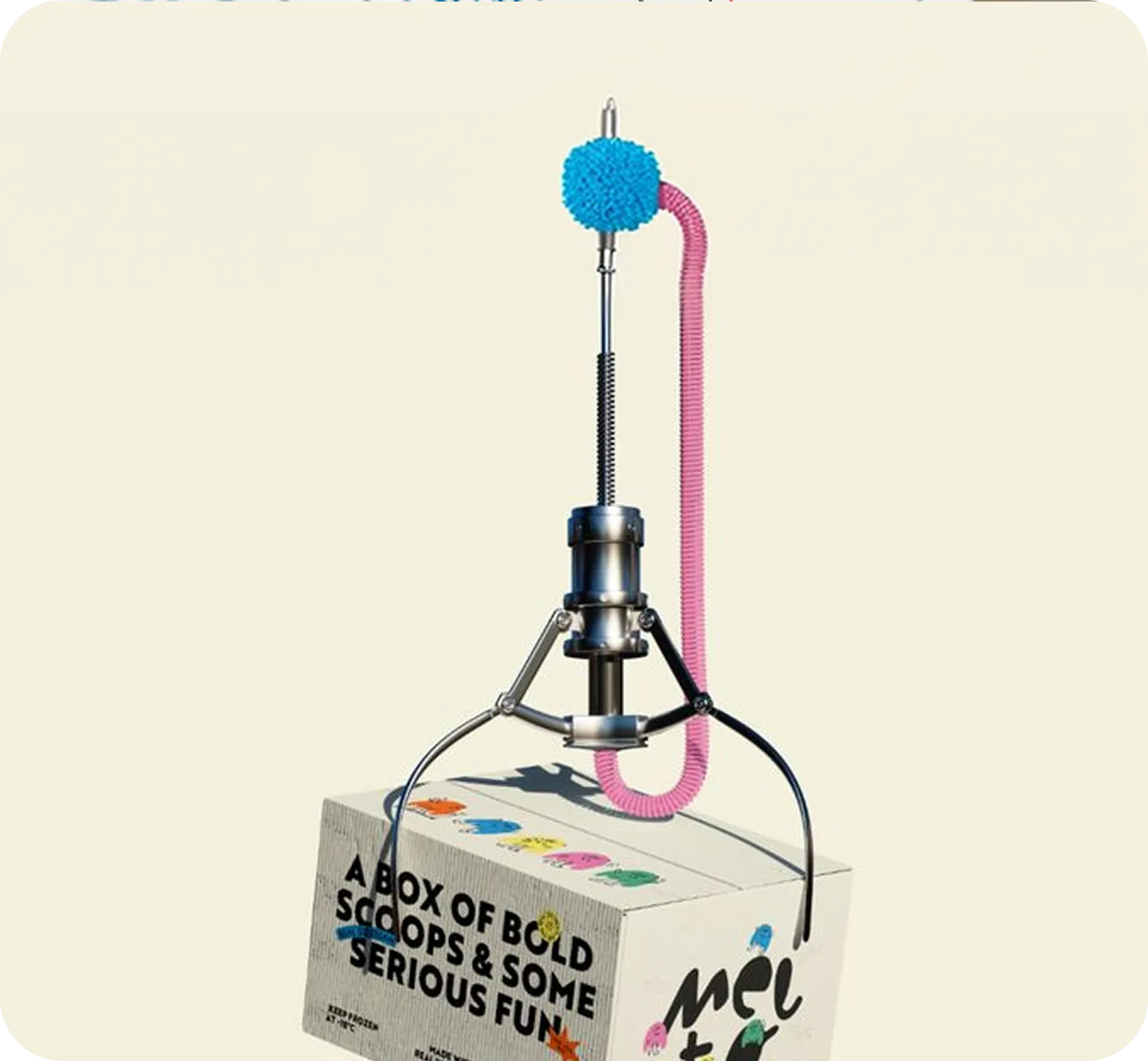 A claw machine lifting a branded ice-cream box