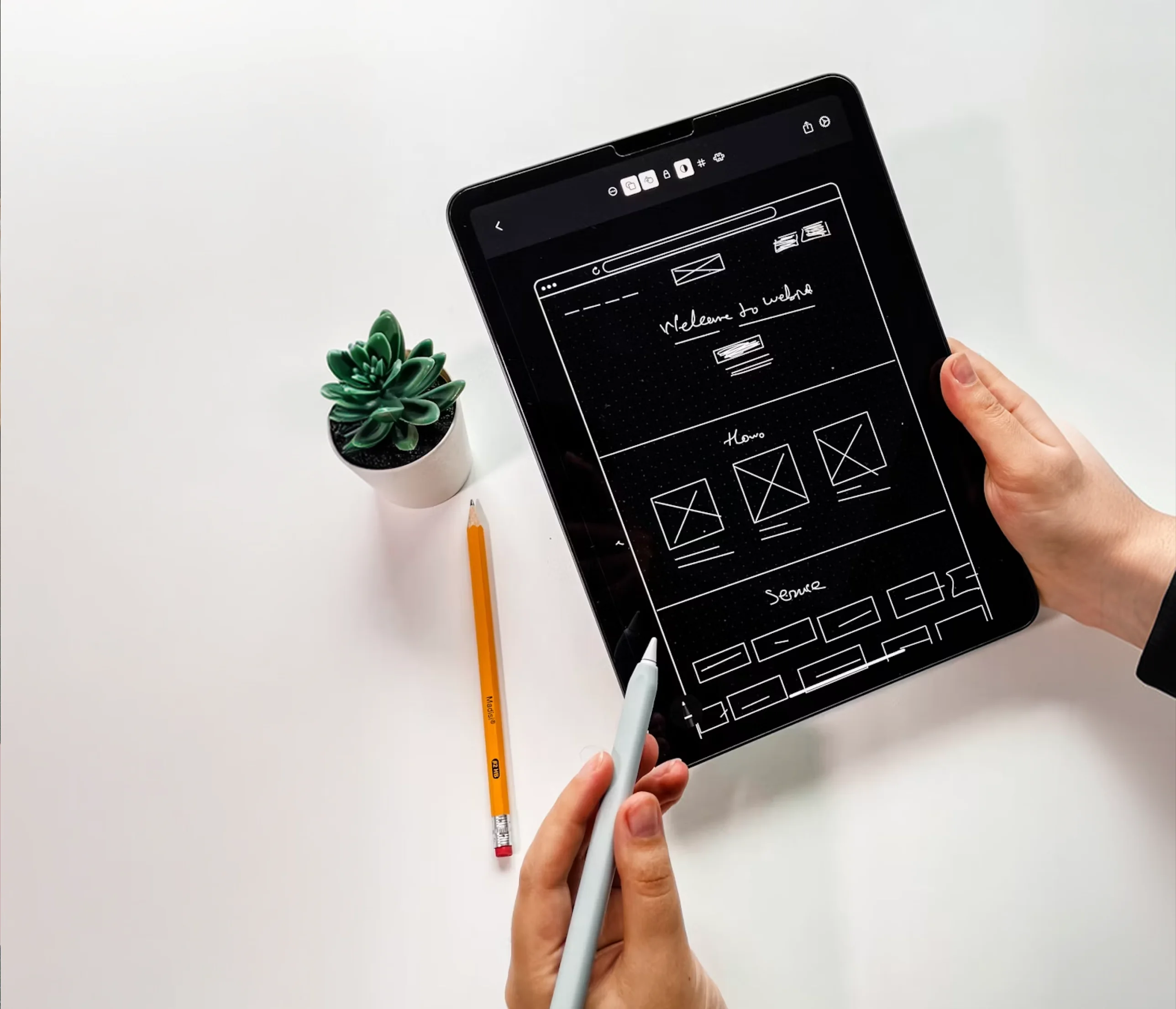 A website wireframe sketched on a tablet